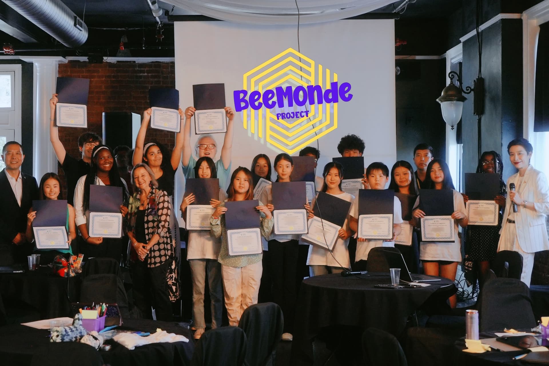 Students holding up certificates of completion