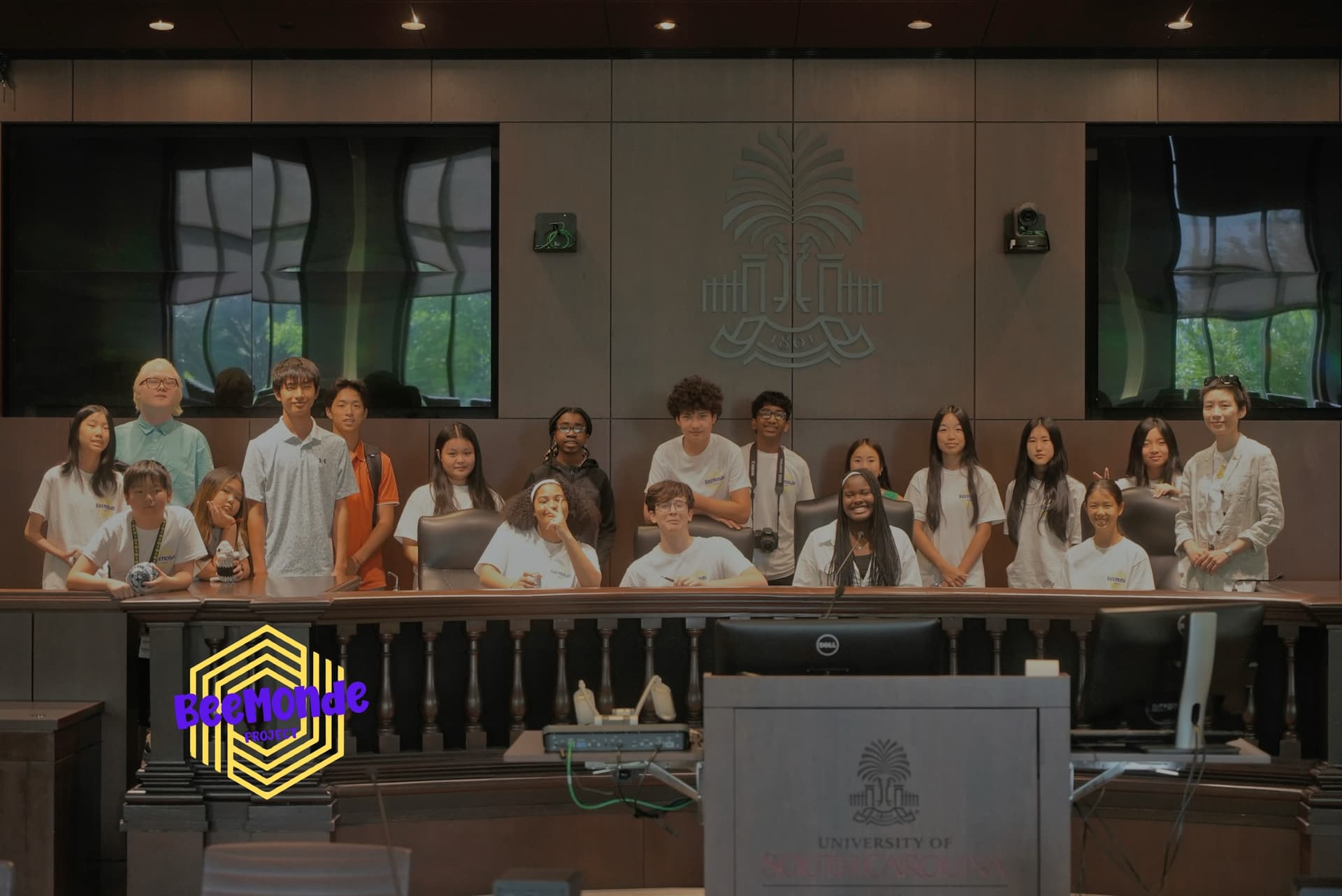 Students posing for a group photo inside a University of South Carolina meeting room