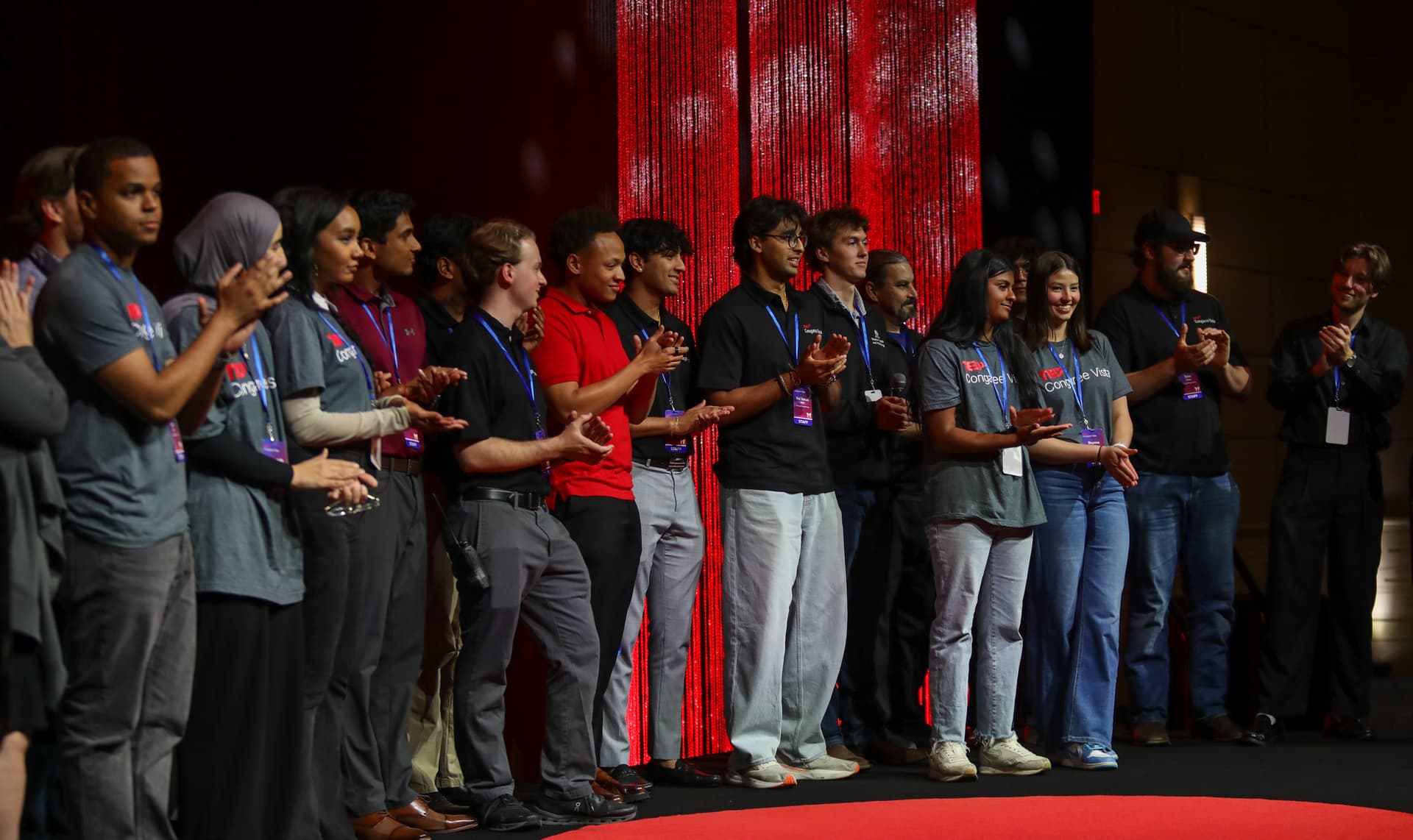 The Inspire Columbia team applauding together on stage at TEDxCongaree Vista