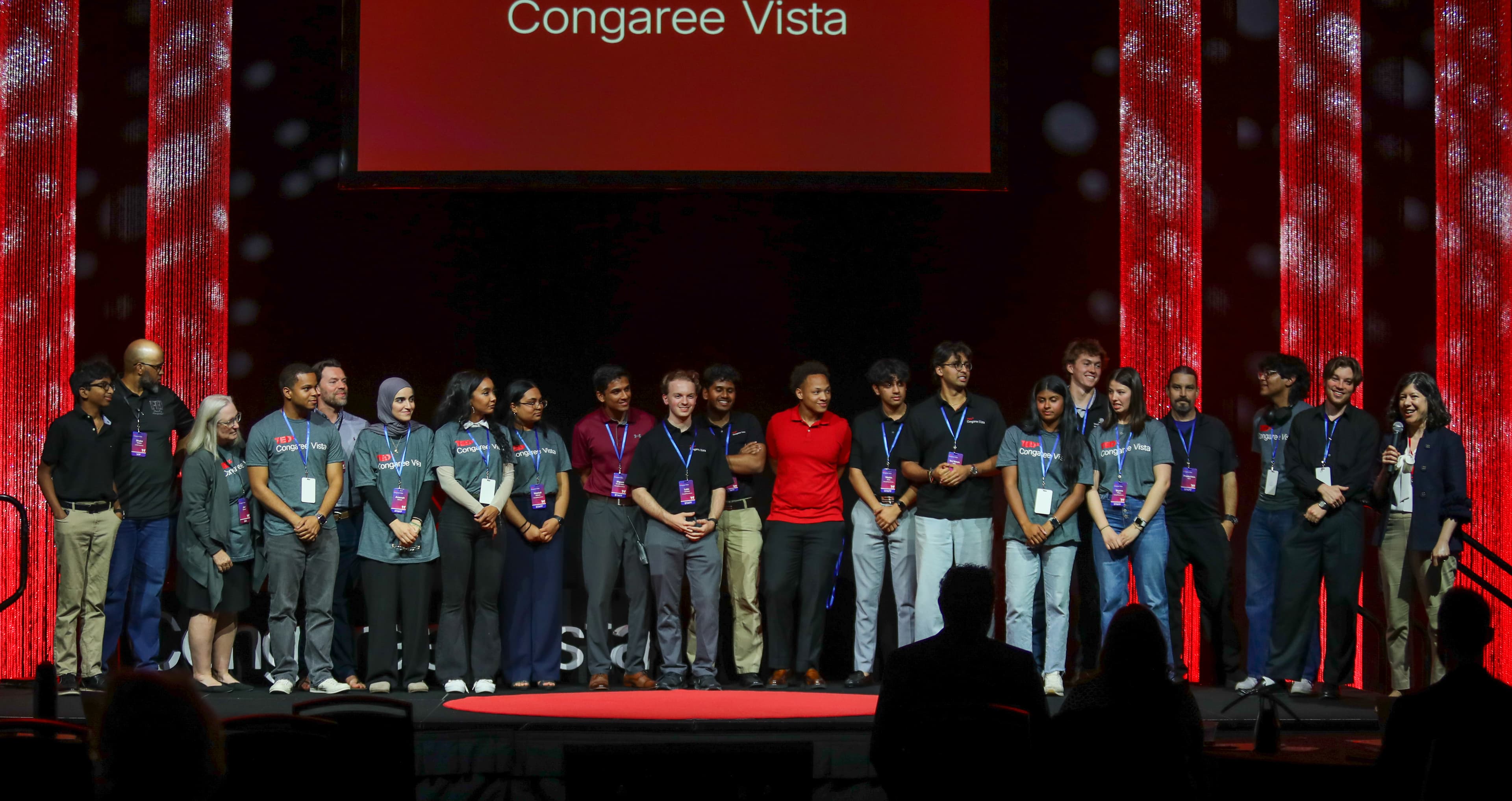 The full Inspire Columbia team standing together on stage at TEDxCongaree Vista